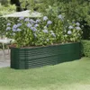 A green metal raised garden bed filled with hydrangeas, situated on a lawn next to a patio table and umbrella. Voir les images du produit