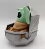 A plush toy of Baby Yoda from The Mandalorian is sitting in its pram. Produktbild-Vorschau