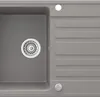 A close-up view of a gray kitchen sink with a drain and a ribbed drying area. Náhled obrázku produktu
