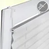 Close-up of a white pleated blind attached to a window frame without drilling. Produktbild-Vorschau