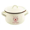 A cream-colored enamel pot with a lid and handles, decorated with a heart design, is shown against a white background. Anteprima dell’immagine prodotto