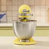 A yellow KitchenAid stand mixer with a silver bowl is shown on a countertop in front of a tiled backsplash. Produktbild-Vorschau