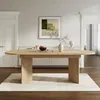 A wooden oval dining table is shown in a well-lit room with a rug underneath. Anteprima dell’immagine prodotto