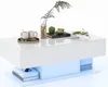 A white coffee table with LED lighting, featuring two drawers, a decorative plant, two mugs on a tray, a book, and sliced apples. Voir les images du produit