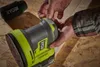 A person is using a Ryobi sander on a wooden surface. Podgląd zdjęcia produktu
