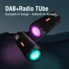 Two black portable speakers with colorful LED lights are displayed against a dark, abstract background. Produktbild-Vorschau