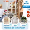 A woman is installing a white safety gate with orange accents on a staircase, while a cat sits below and a dog with a ball is on the stairs above. Three circular insets show the gate in different room settings. Produktbild-Vorschau