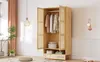 A light wood wardrobe with doors open, revealing clothes and storage boxes, in a well-lit room with decorative elements. Produktbild-Vorschau