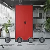 A red metal cabinet is shown in a modern office setting with plants and office chairs visible in the background. Produktbild-Vorschau