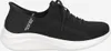 A black Skechers sneaker with a white sole is shown against a white background. Produktbild-Vorschau