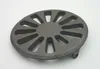 A round, cast iron grate with a spoke-like pattern and a small protrusion on the side, set against a white background. Podgląd zdjęcia produktu