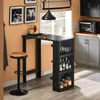 A kitchen or dining area with a bar table and stool, bottles, glasses, and jars on shelves. Produktbild-Vorschau