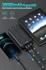 A solar power bank is shown charging a smartphone and a tablet simultaneously. Produktbild-Vorschau