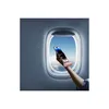 A hand holding a pink power bank and a smartphone in front of an airplane window. Voir les images du produit
