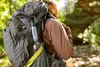 A person hiking in a forest with a backpack. Podgląd zdjęcia produktu