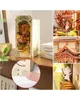 A collage of images showing a 3D wooden model of a Japanese-style building with cherry blossoms, a close-up of the model's construction, and a finger interacting with the model. Náhled obrázku produktu