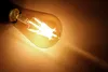 A close-up shot of a lit LED filament light bulb. Produktbild-Vorschau