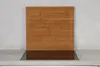 A wooden cutting board placed on top of a stovetop. Produktbild-Vorschau