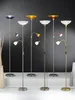 A collection of floor lamps with different colored shades and adjustable reading lights. Anteprima dell’immagine prodotto
