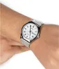 A person's wrist wearing a silver Casio watch with a white dial. Produktbild-Vorschau
