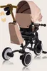 A studio shot of a beige and black children's tricycle. Podgląd zdjęcia produktu