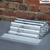 A stack of silver-wrapped sealant tubes in front of a brick wall. Produktbild-Vorschau