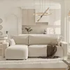 A modern living room with a sectional sofa and an open-plan kitchen in the background. Voir les images du produit