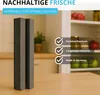 A gray filter set is shown in a kitchen-like setting with shelves of food in the background. Produktbild-Vorschau