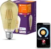 A smart LED light bulb, its packaging, and a smartphone displaying a control app. Produktbild-Vorschau
