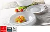 A table setting with white plates, a bowl, and tulips. Anteprima dell’immagine prodotto