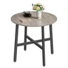 A round wooden table with a metal base, decorated with a vase of flowers and a cup of coffee. Náhled obrázku produktu