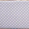 A close-up view of a fabric with a polka dot pattern. Anteprima dell’immagine prodotto