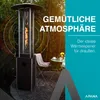 A gas patio heater is shown in an outdoor setting with bamboo in the background, a table and chair, and text overlays. Produktbild-Vorschau