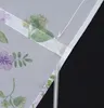 A close-up view of a sheer curtain with a floral pattern. Produktbild-Vorschau