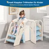 A young girl is sitting on a child's step stool next to a toilet. Produktbild-Vorschau
