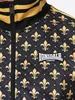 Close-up of a black and gold patterned jacket. Náhled obrázku produktu