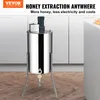 A stainless steel honey extractor is shown in a kitchen setting with cabinets in the background. Náhľad obrázku produktu