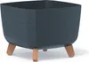 A dark gray planter with a speckled texture and four brown legs is shown against a white background. Produktbild-Vorschau