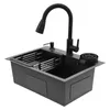 A black kitchen sink with a faucet and accessories, isolated on a white background. Podgląd zdjęcia produktu