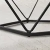 Close-up view of the black metal base of a piece of furniture, possibly a table or chair, on a textured surface. Náhled obrázku produktu
