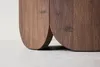 Close-up of the bottom of a wooden table with curved legs. Produktbild-Vorschau