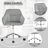 A grey office chair is shown in a studio setting with marketing text overlays highlighting its features. Produktbild-Vorschau