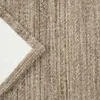 A close-up view of a textured fabric, possibly a rug or blanket, showing the weave and a contrasting white underside. Produktbild-Vorschau