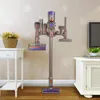 A vacuum cleaner accessory holder with various attachments displayed against a patterned wallpaper. Produktbild-Vorschau