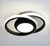 A modern LED ceiling light with interlocking rings, illuminated against a neutral background. Produktbild-Vorschau