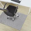 An office chair on a gray chair mat in front of a white desk. Podgląd zdjęcia produktu