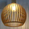 A close-up shot of a wooden pendant light fixture. Voir les images du produit