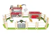 A toy dinosaur enclosure playset with wooden fences, buildings, and dinosaur figures. Produktbild-Vorschau