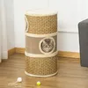 A cat is peeking out of a multi-level cat scratching post. Produktbild-Vorschau