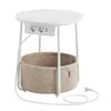 A round side table with integrated power outlets and USB ports, featuring a fabric basket underneath for storage. Produktbild-Vorschau